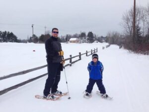 Father and son snowshoe