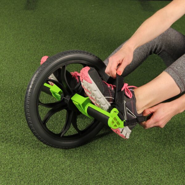 Woman straps in feet to Smart Core Ab Wheel