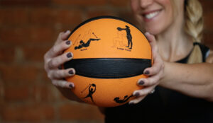 smiling woman holds Smart Medicine Ball