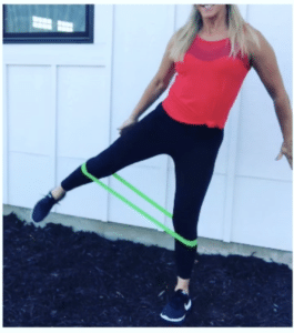 woman does mini bands adductor strengthening exercise