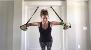 woman does Smart Straps push up in front of white door
