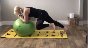 Woman does mountain climbers exercise with forearms on Smart Stability Ball